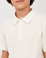 Close-up of cream waffle knit polo shirt collar for boys